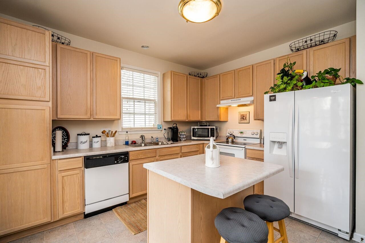 5641 Picnic Rock Lane Raleigh, NC 27613 - Photo 11 of 23 a kitchen with stainless steel appliances a refrigerator sink and cabinets