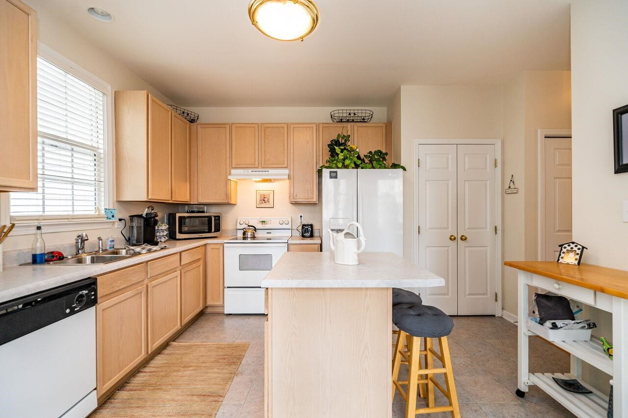 5641 Picnic Rock Lane Raleigh, NC 27613 - Photo 12 of 23 a large kitchen with stainless steel appliances granite countertop a stove a sink and a refrigerator