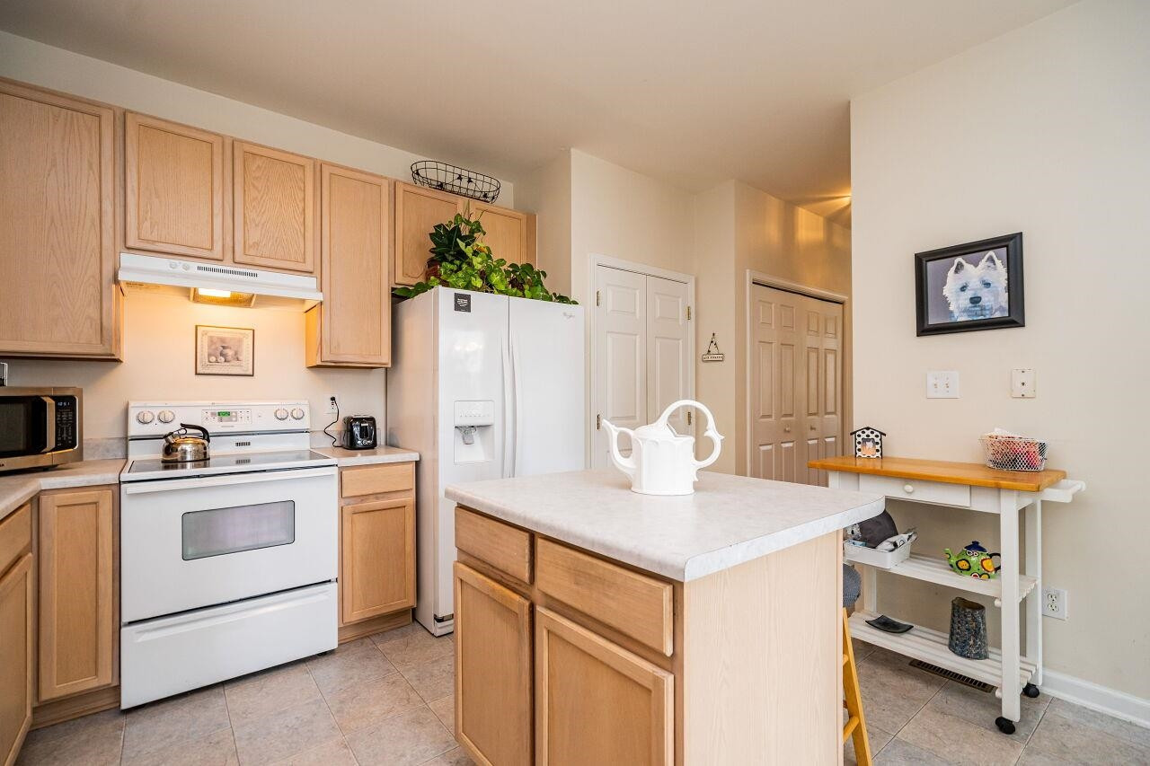 5641 Picnic Rock Lane Raleigh, NC 27613 - Photo 13 of 23 a kitchen with a sink a stove a refrigerator and cabinets