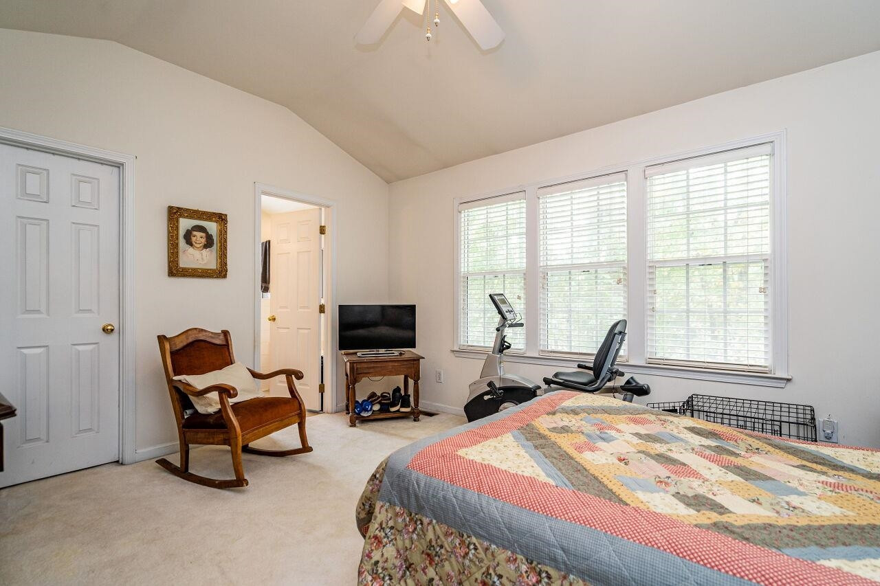 5641 Picnic Rock Lane Raleigh, NC 27613 - Photo 17 of 23 a bedroom with furniture and a flat screen tv