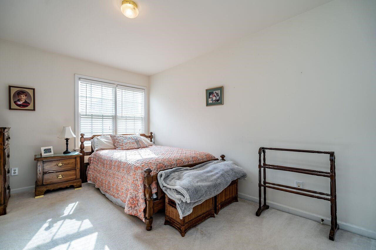 5641 Picnic Rock Lane Raleigh, NC 27613 - Photo 21 of 23 a bedroom with a bed and a window