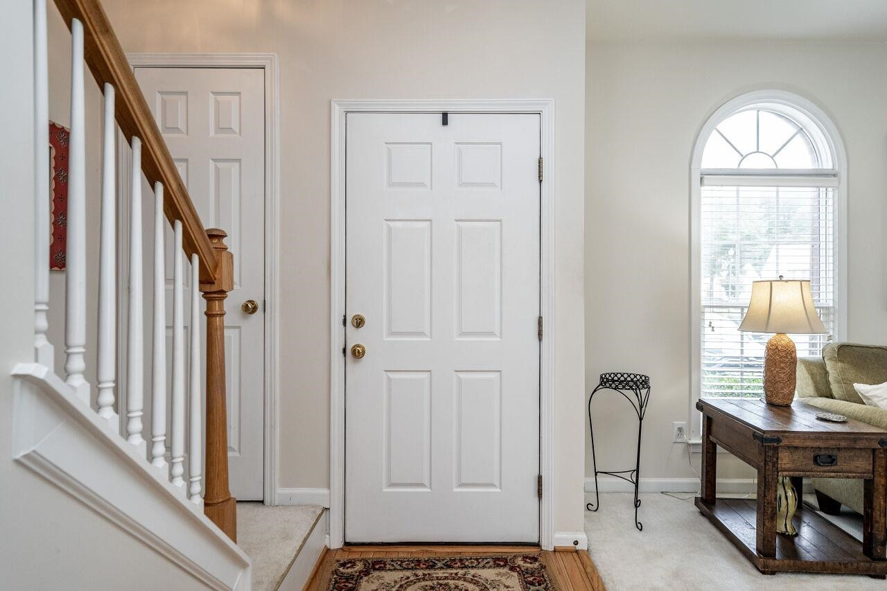 5641 Picnic Rock Lane Raleigh, NC 27613 - Photo 4 of 23 a view of an entryway with wooden floor and windows