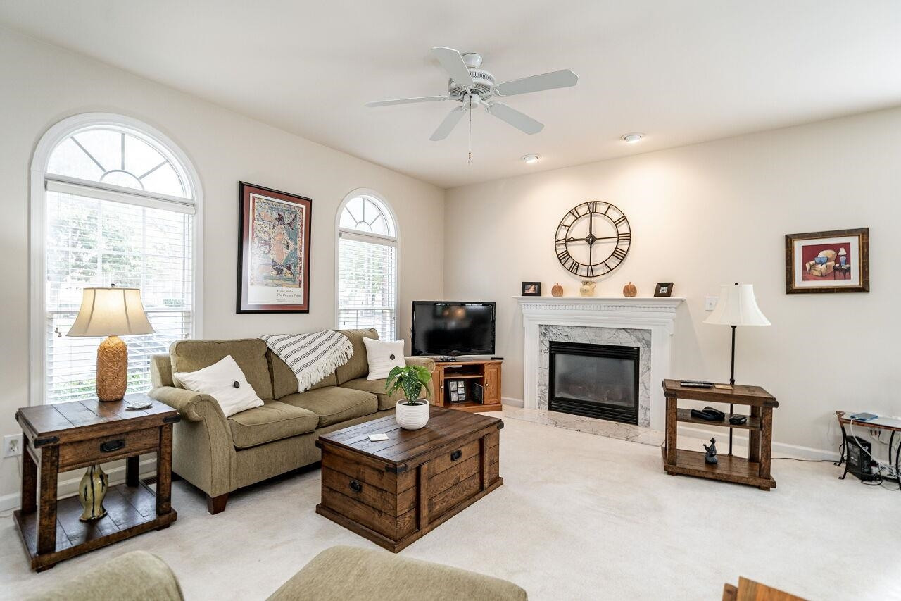 5641 Picnic Rock Lane Raleigh, NC 27613 - Photo 7 of 23 a living room with furniture a fireplace and a flat screen tv