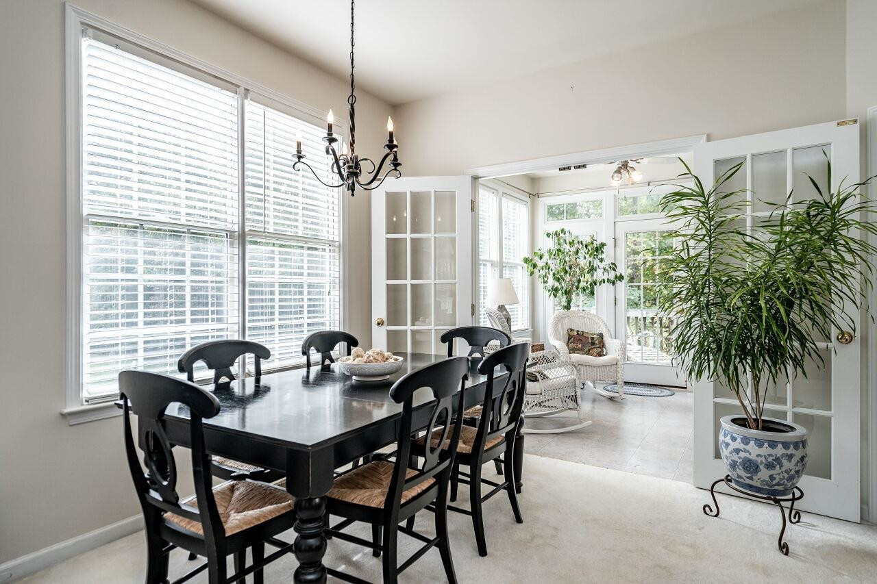 5641 Picnic Rock Lane Raleigh, NC 27613 - Photo 9 of 23 a view of a dining room and livingroom with furniture wooden floor and a chandelier