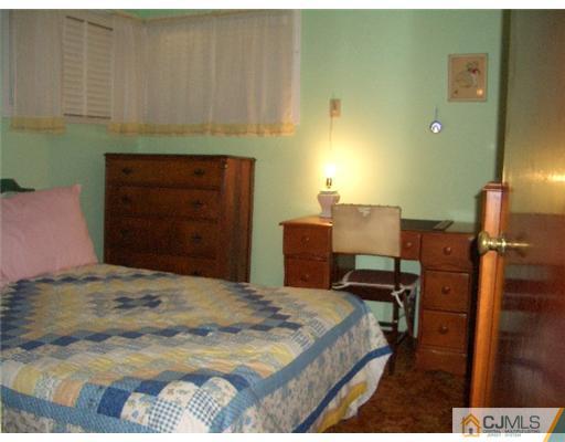 2 Colfax Road Edison, NJ 08817 - Photo 12 of 25 a bedroom with a bed and a dresser