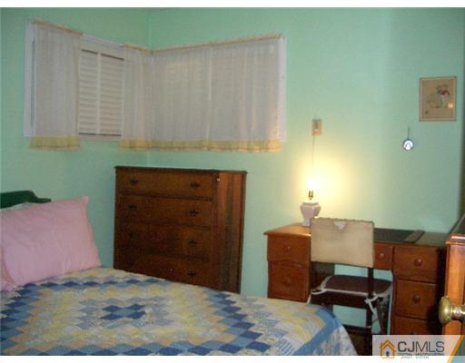 2 Colfax Road Edison, NJ 08817 - Photo 13 of 25 a bedroom with a bed and furniture
