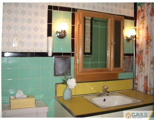 2 Colfax Road Edison, NJ 08817 - Photo 18 of 25 a bathroom with a sink and a mirror