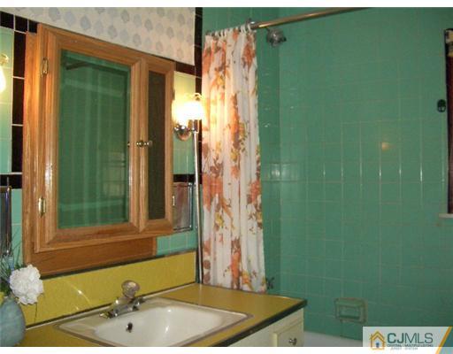 2 Colfax Road Edison, NJ 08817 - Photo 19 of 25 a bathroom with a sink and a mirror