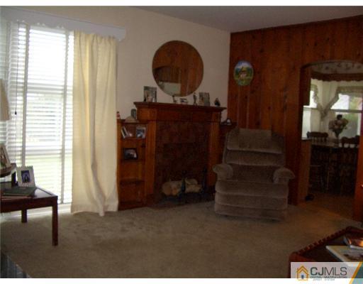2 Colfax Road Edison, NJ 08817 - Photo 5 of 25 a living room with furniture and a fireplace