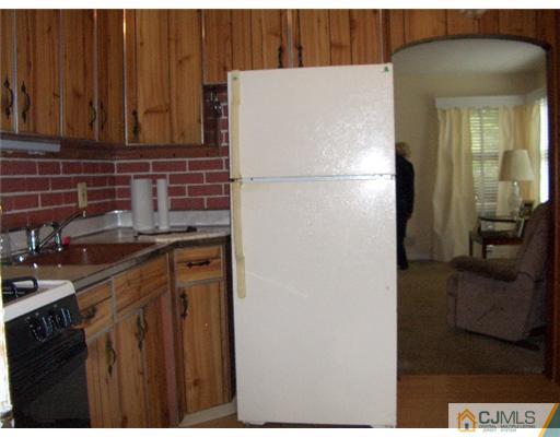 2 Colfax Road Edison, NJ 08817 - Photo 10 of 25 a white refrigerator freezer sitting inside of a kitchen