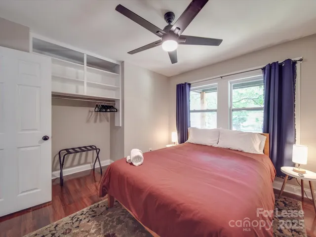 a bedroom with a large bed and a window