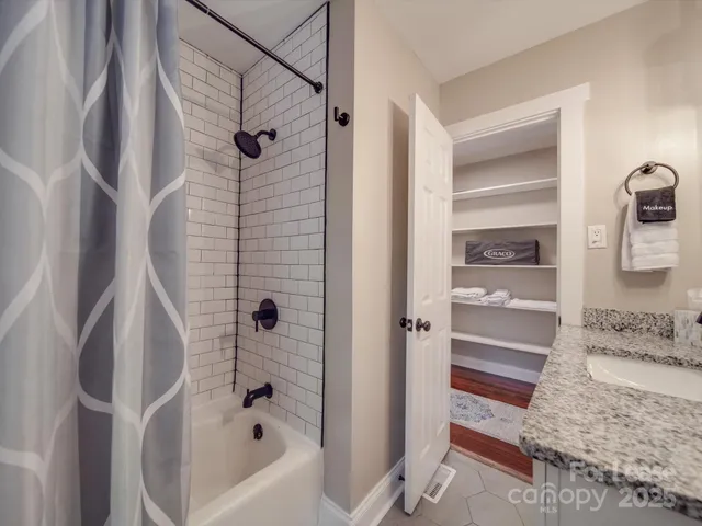 a bathroom with a tub and a shower