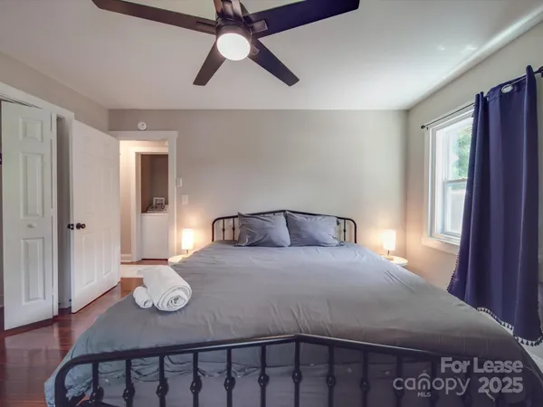 a bedroom with a bed and chandelier