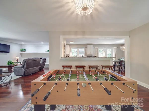 a living room with furniture and a chandelier