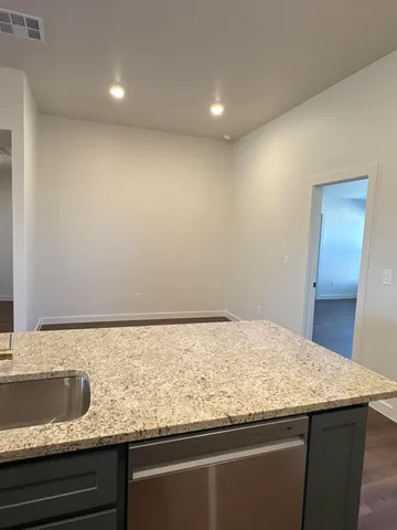 a bathroom with a granite countertop sink and vanity