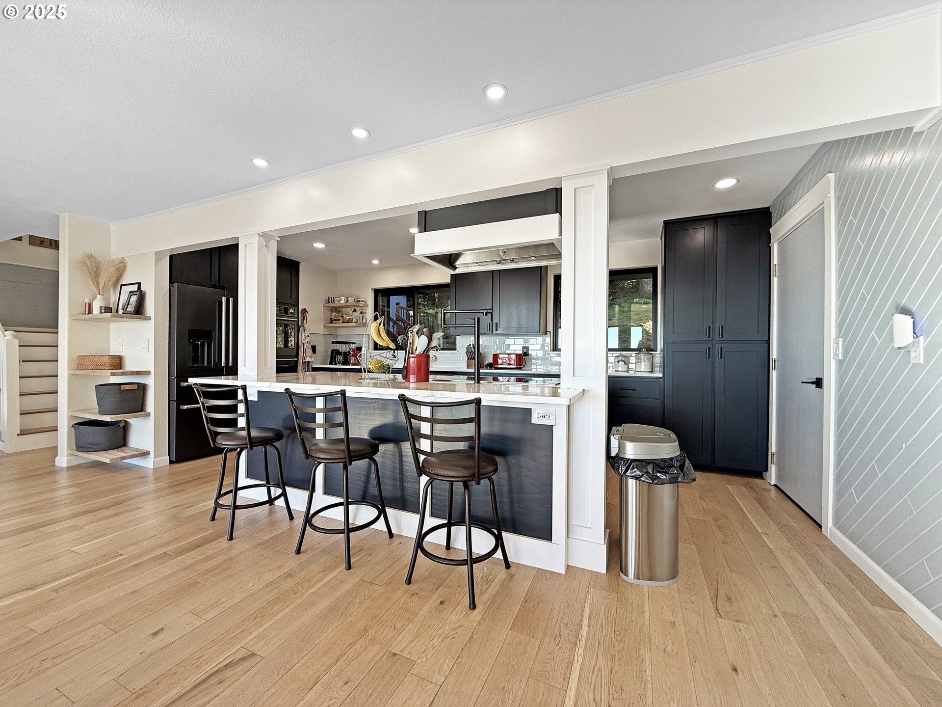 18950 Timeus Ranch Road Brookings, OR 97415 - Photo 11 of 47 a kitchen with stainless steel appliances kitchen island granite countertop wooden floors and cabinets