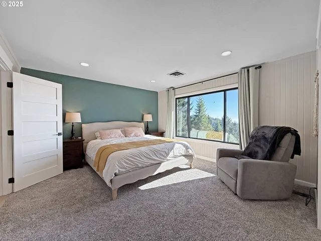 a spacious bedroom with a bed and a couch