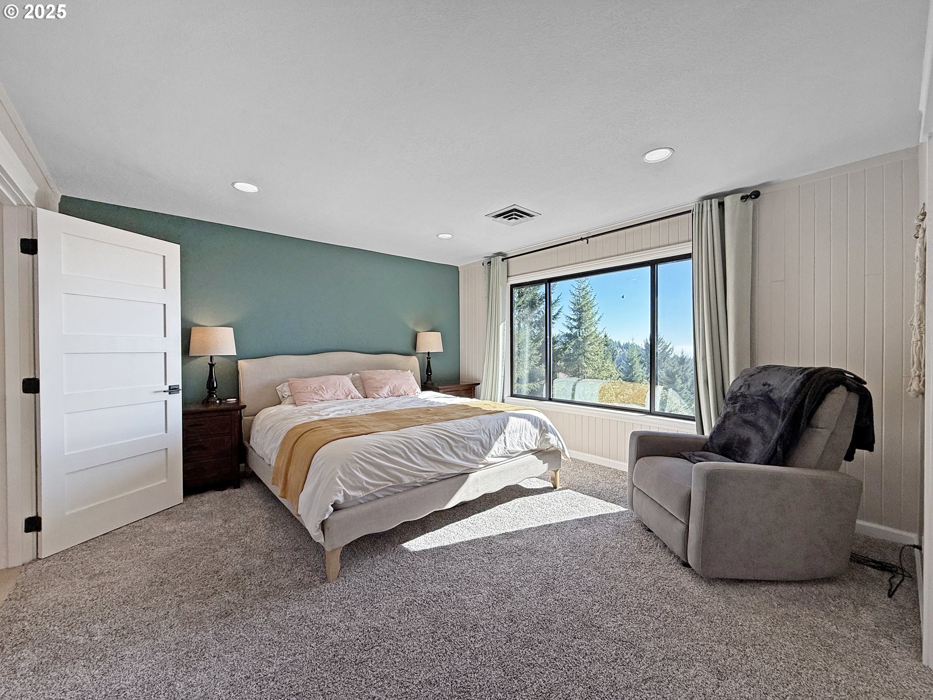 18950 Timeus Ranch Road Brookings, OR 97415 - Photo 18 of 47 a spacious bedroom with a bed and a couch