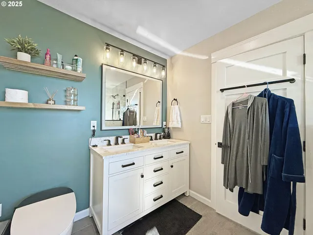 a bathroom with a sink vanity mirror and toilet