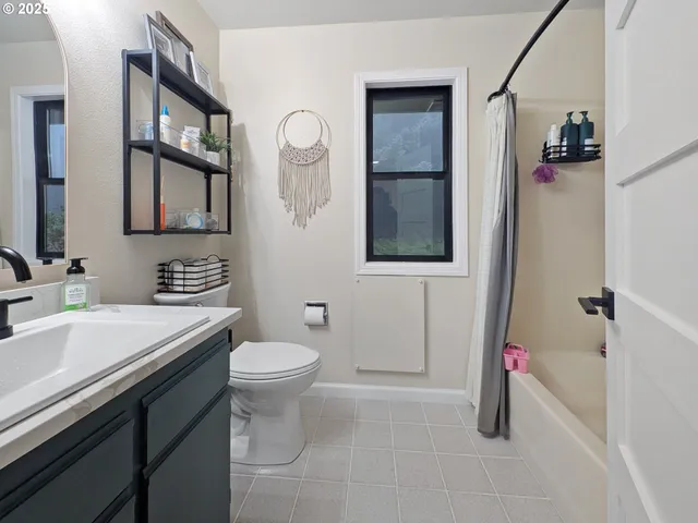a bathroom with a sink toilet and a mirror