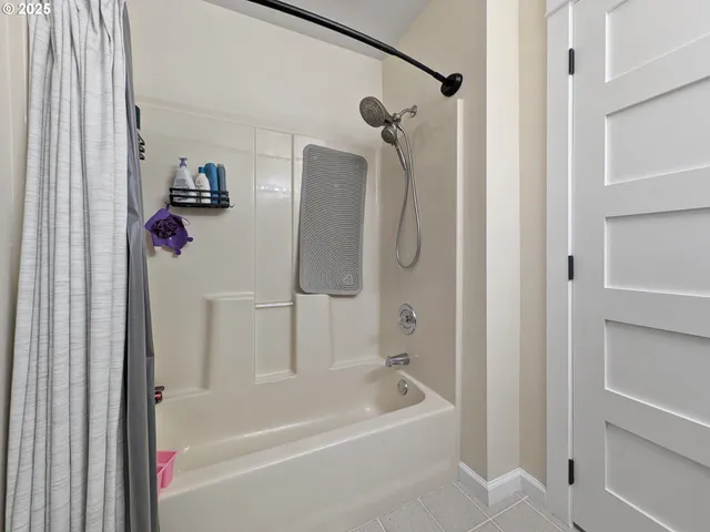 a bathroom with a bathtub a shower and a shower