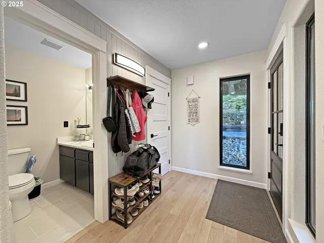 a view of a livingroom with furniture and bathroom