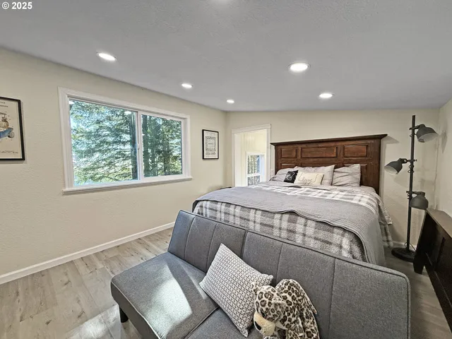 a bedroom with a large bed and a window