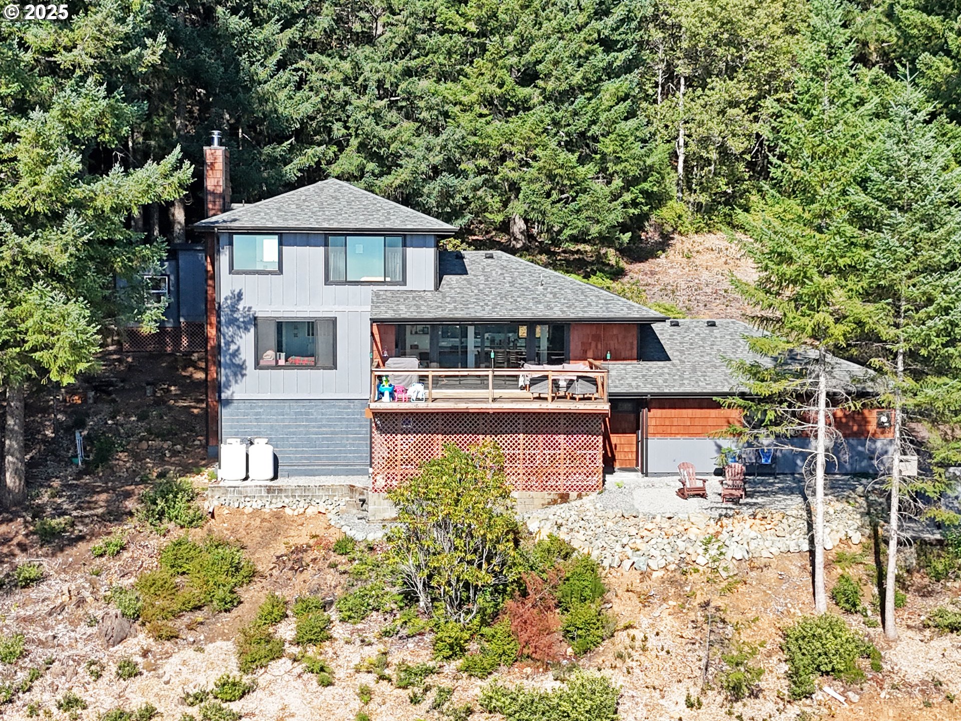 18950 Timeus Ranch Road Brookings, OR 97415 - Photo 4 of 47 a front view of a house with garden