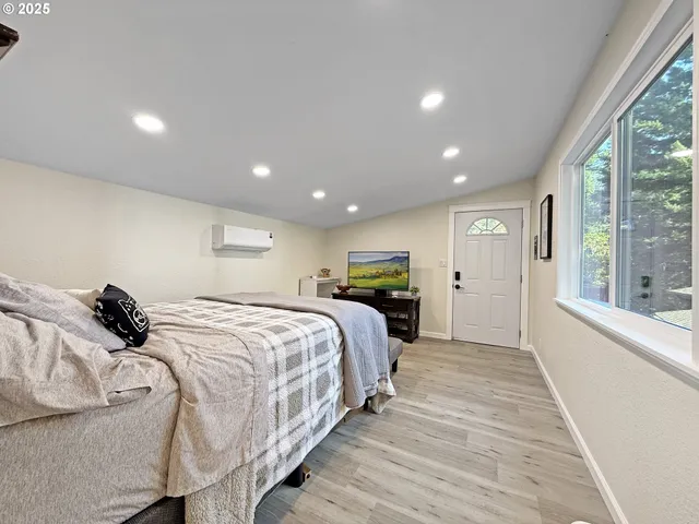 a bed room with a bed and a large window