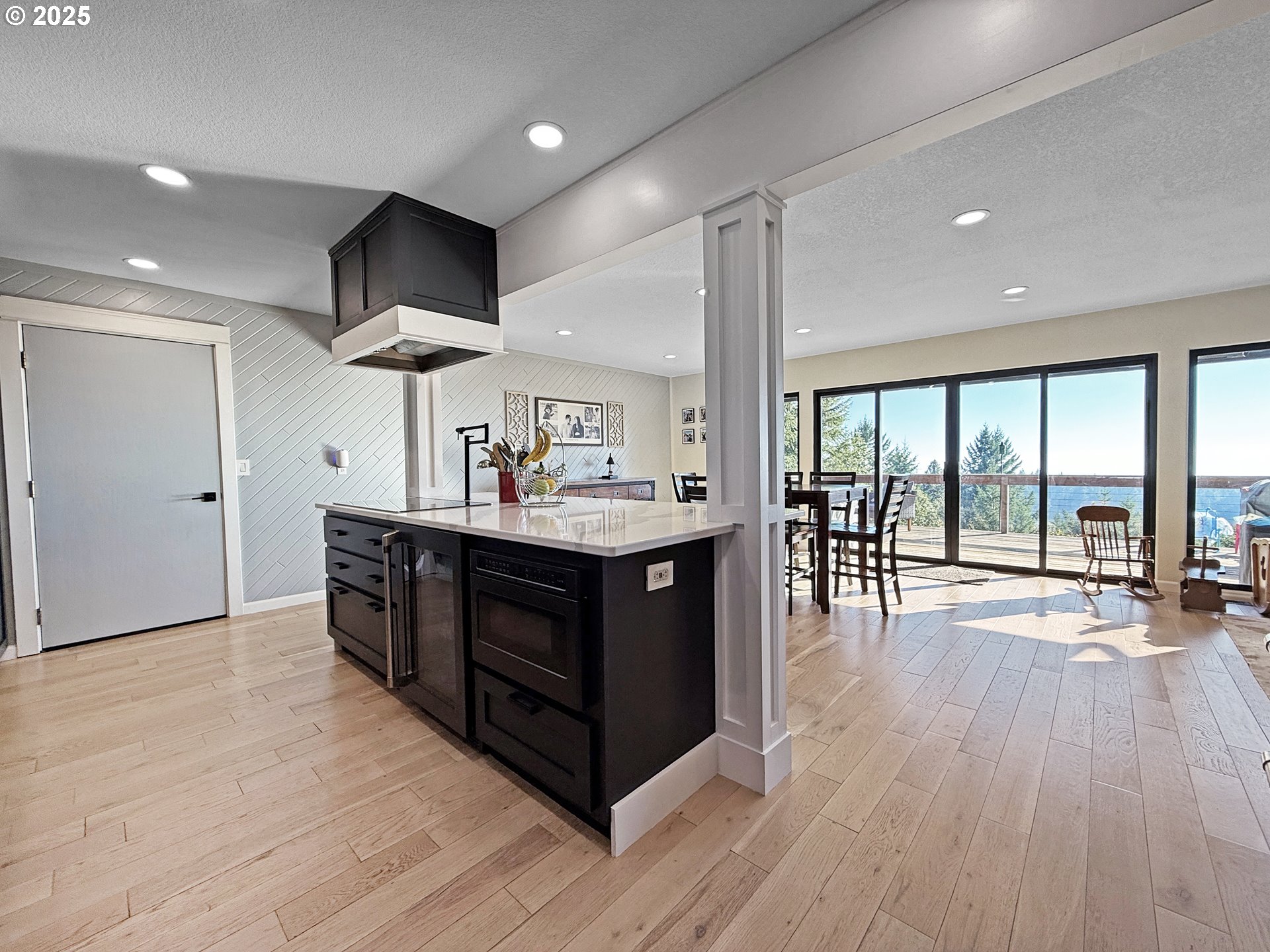 18950 Timeus Ranch Road Brookings, OR 97415 - Photo 9 of 47 a kitchen with a wooden floor and a large window