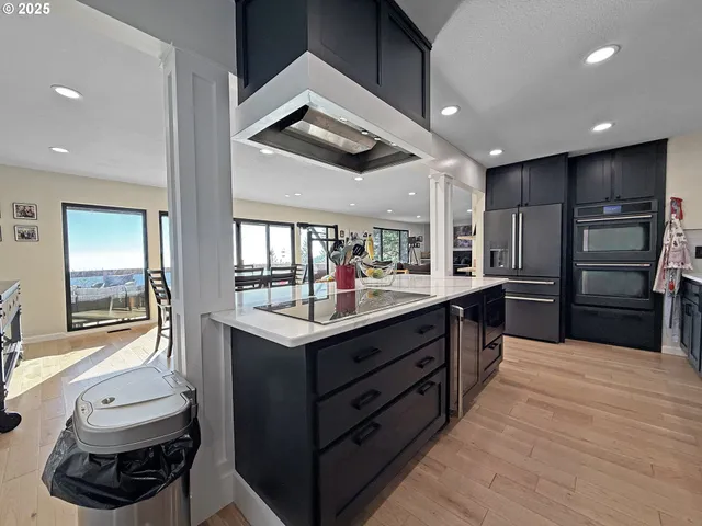 a kitchen with kitchen island a sink stainless steel appliances and cabinets