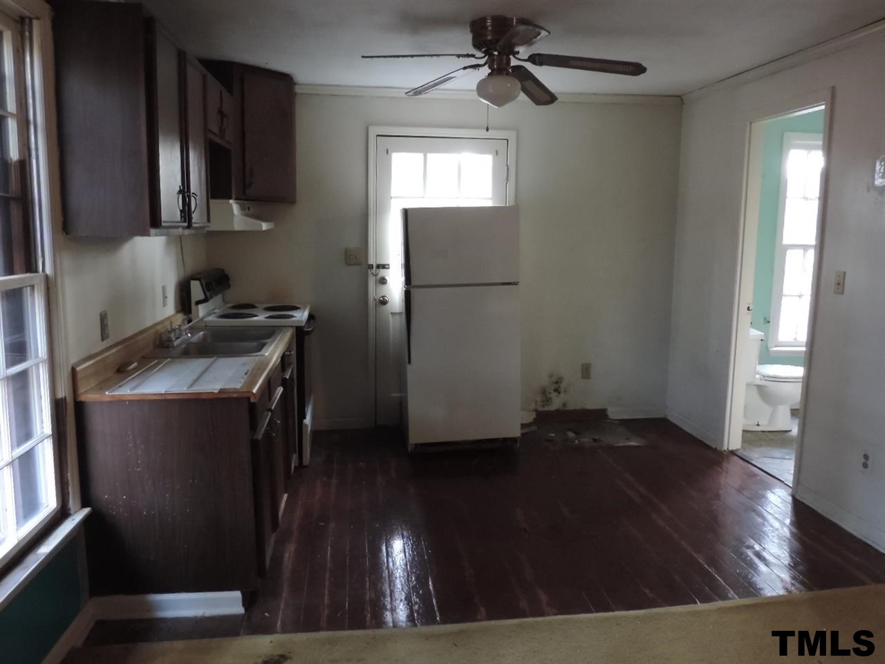 6020 Neuse Street Raleigh, NC 27610 - Photo 15 of 25 a kitchen with a refrigerator and a stove top oven