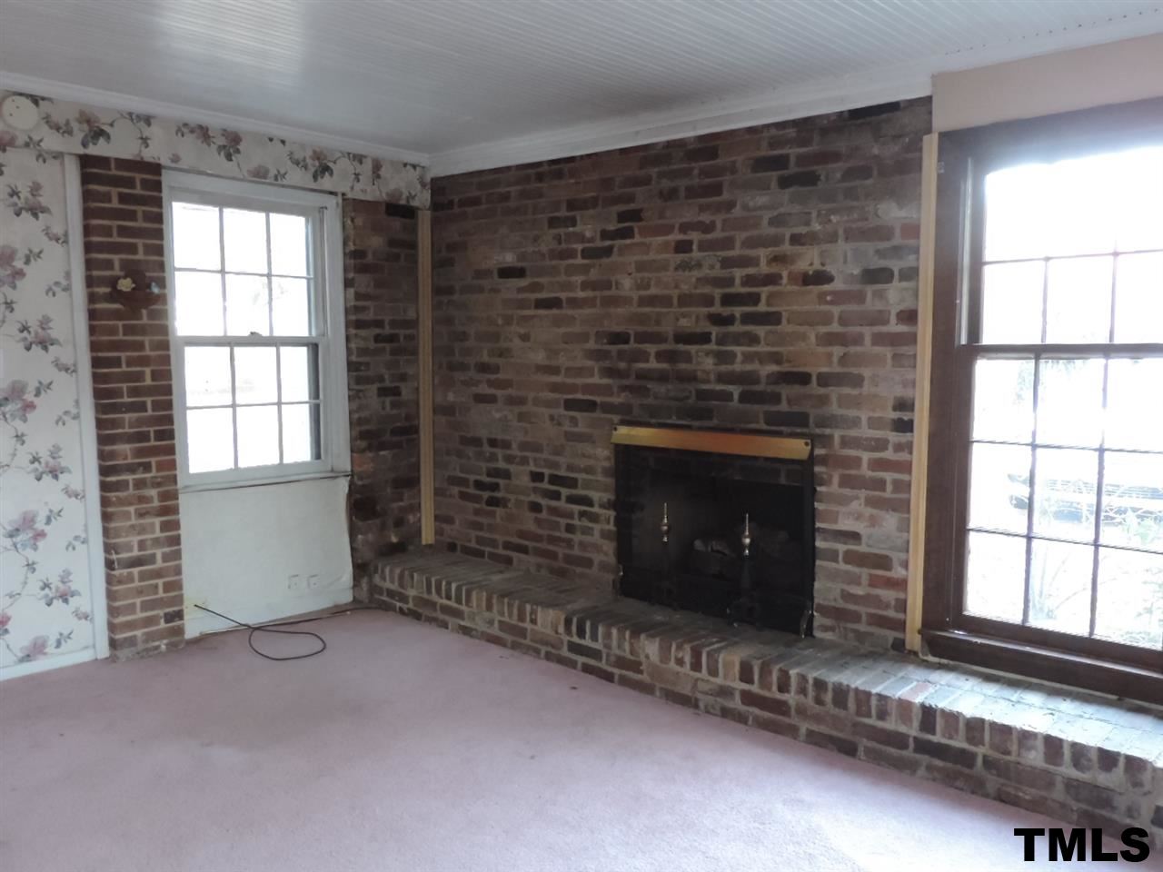 6020 Neuse Street Raleigh, NC 27610 - Photo 5 of 25 a living room with a fireplace and a window