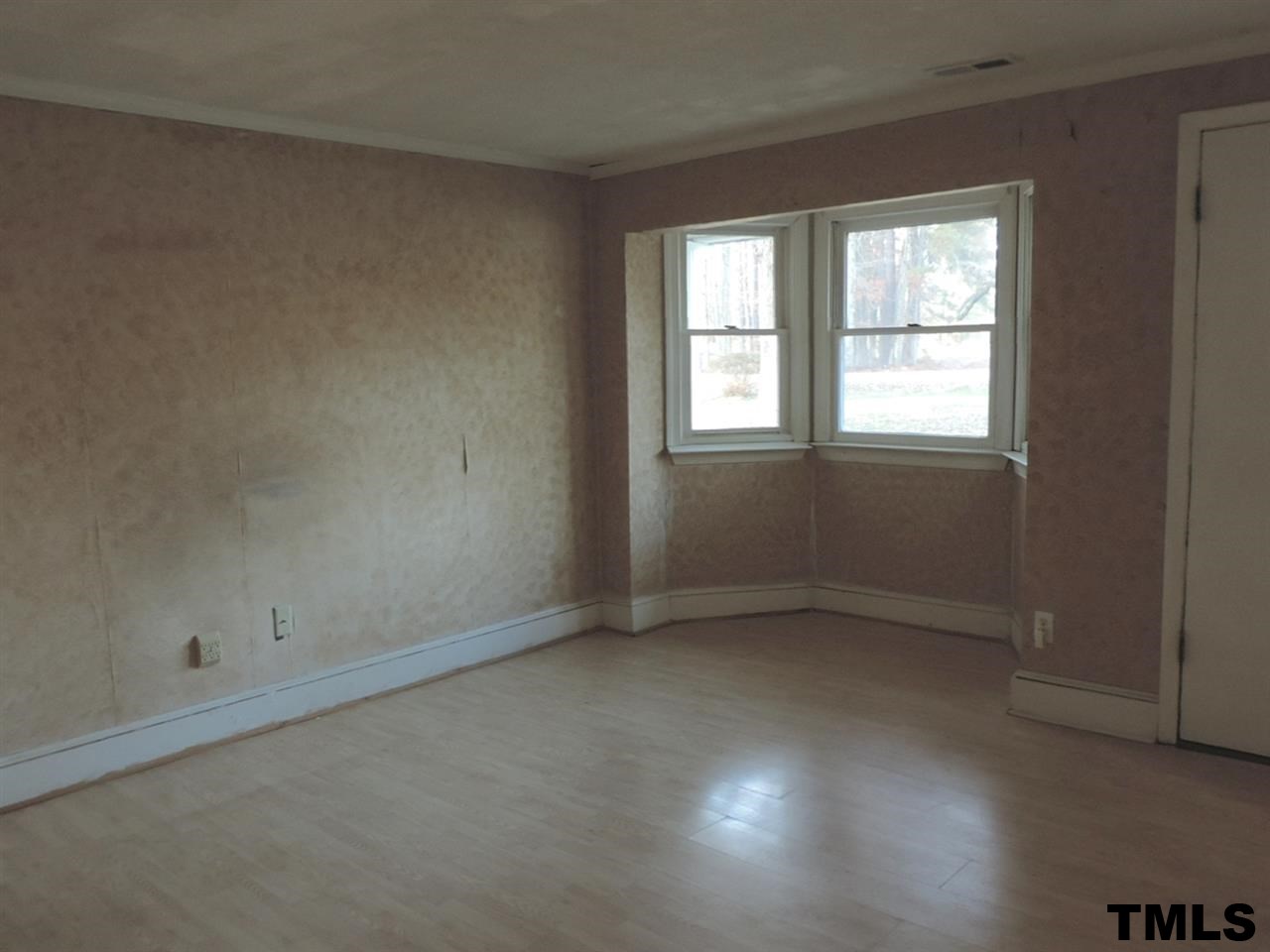 6020 Neuse Street Raleigh, NC 27610 - Photo 7 of 25 an empty room with a window