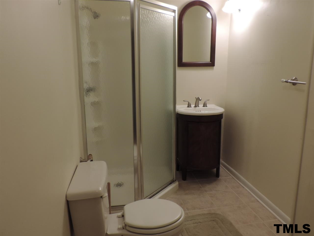 6020 Neuse Street Raleigh, NC 27610 - Photo 9 of 25 a bathroom with a toilet sink and mirror