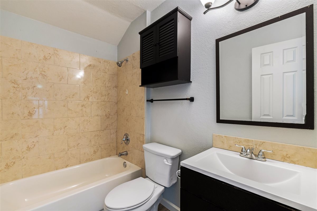 2147 Jasmine Path Round Rock, TX 78664 - Photo 25 of 36 A full tub-shower combo with a tiled surround serves guests and secondary bedrooms with ease.