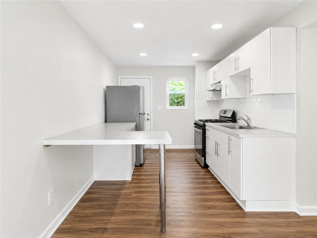 3193 East Point Street, Unit 4 Atlanta, GA 30344 - Photo 6 of 20 a kitchen with a sink cabinets stainless steel appliances and a window