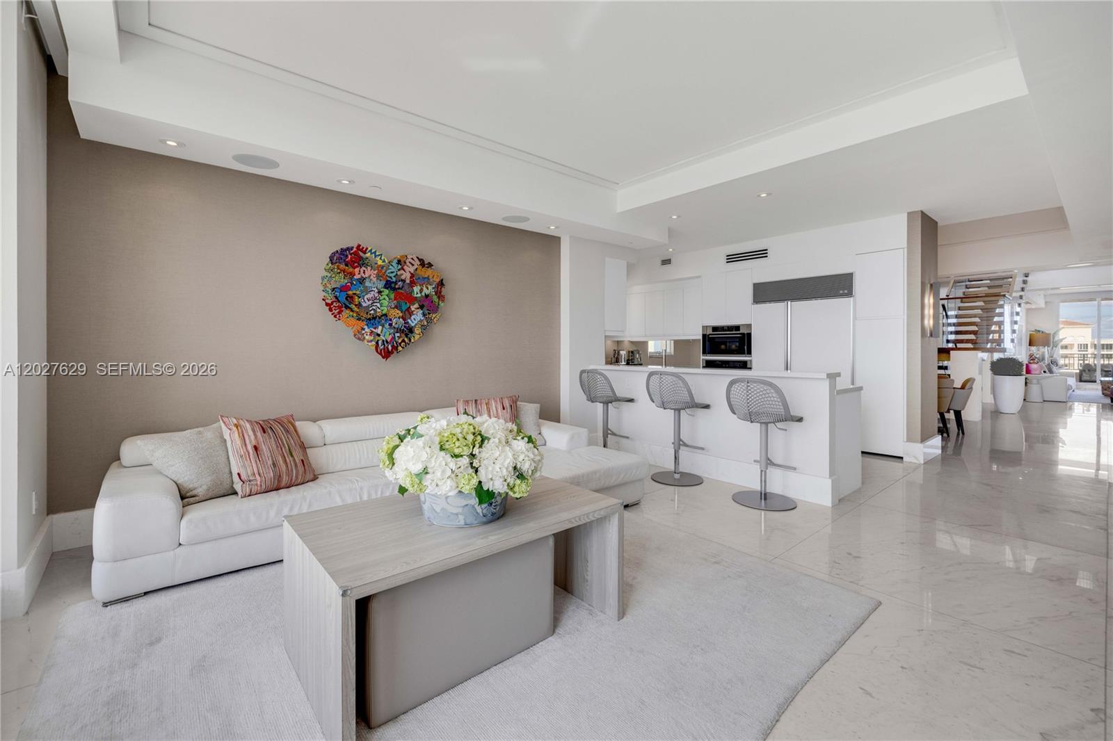 799 Crandon Boulevard, Unit PH8 Key Biscayne, FL 33149 - Photo 9 of 47 a living room with couches and a dining table with kitchen view