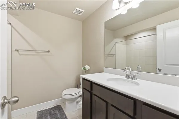 a bathroom with a sink a toilet a mirror and vanity