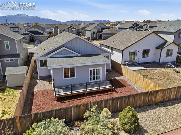a view of a house with wooden fence