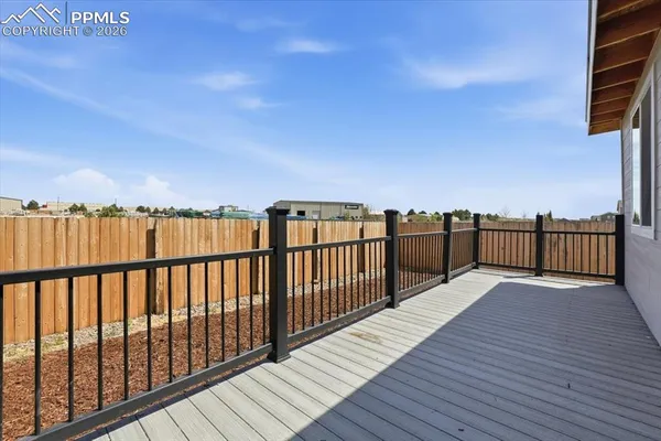 a view of wooden balcony with wooden fence