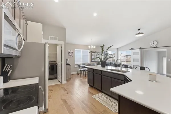 a kitchen with cabinets and stainless steel appliances