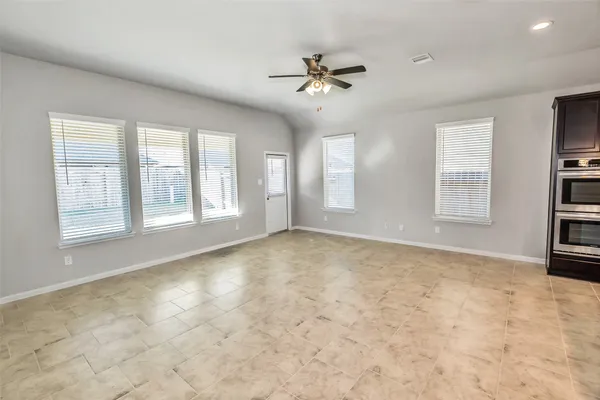 a view of kitchen with sink and refrigerator