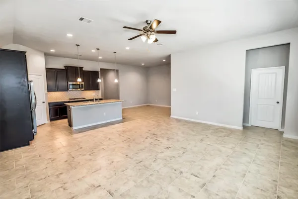 a view of a livingroom with a ceiling fan and window