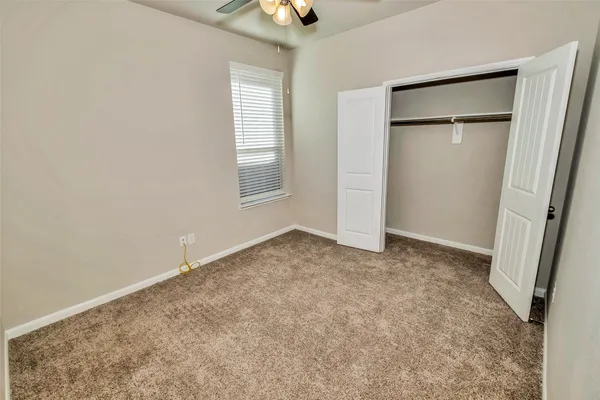 a view of a house with a backyard and a patio