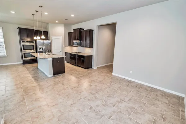 a view of kitchen with furniture and refrigerator
