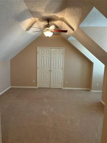 a view of a small space with wooden floor and a window