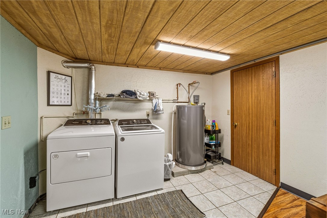86523 North Bay Road Scio, OH 43988 - Photo 15 of 25 Laundry area featuring a textured wall, wood ceiling, independent washer and dryer, water heater, and light tile patterned flooring