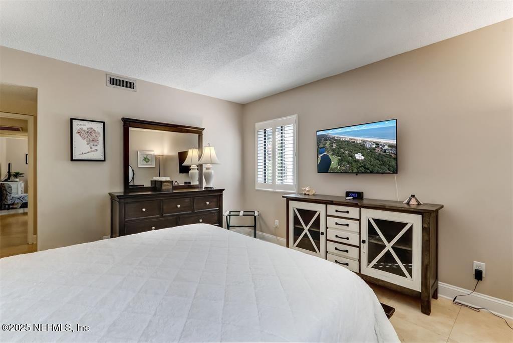 2122 Beachwood Road, Unit 2122 Fernandina Beach, FL 32034 - Photo 18 of 41 a bedroom with a bed and a flat screen tv