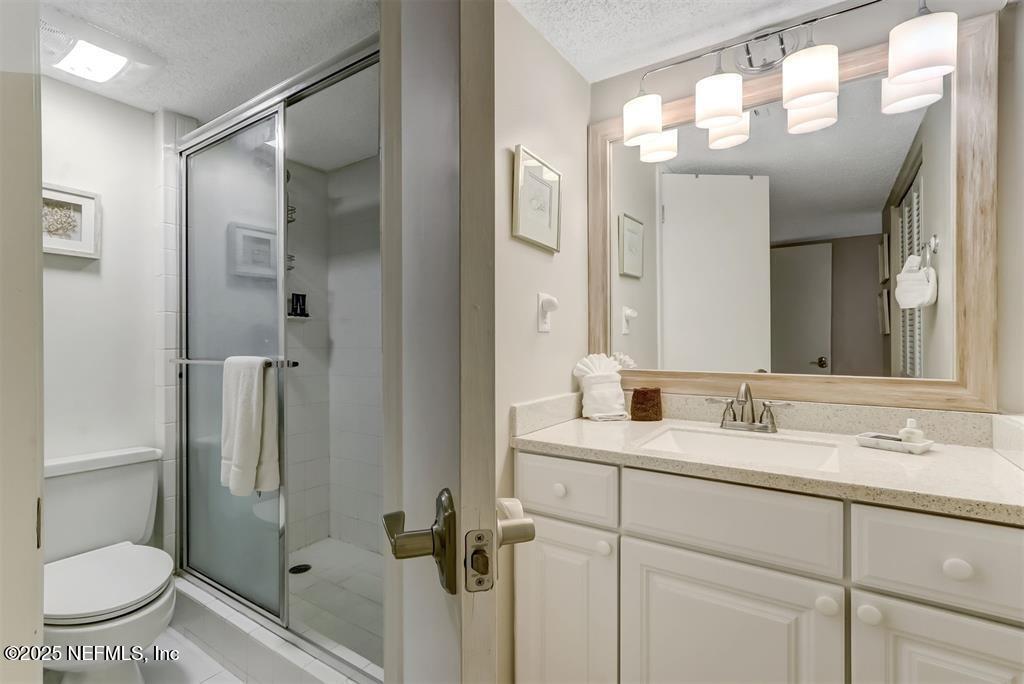 2122 Beachwood Road, Unit 2122 Fernandina Beach, FL 32034 - Photo 19 of 41 a bathroom with a granite countertop sink toilet and shower